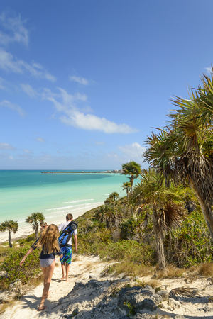 sand dune walk next to aqua ocean