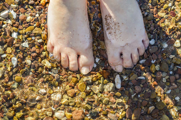 Wading toes in the ocean water Print