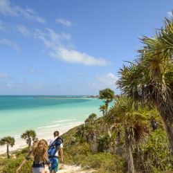 sand dune walk next to aqua ocean