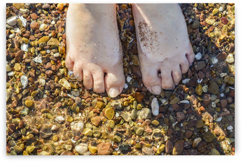 Wading toes in the ocean water by Justin Richard Batten