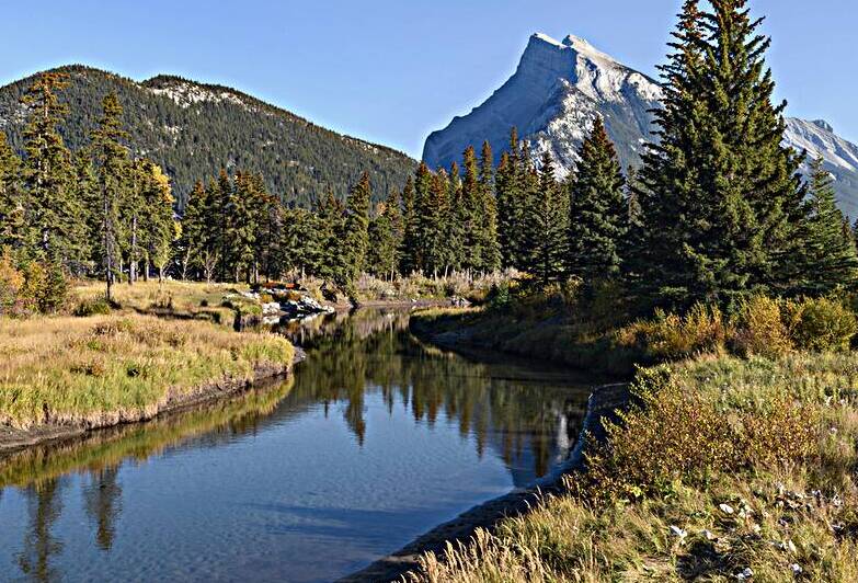 Bow River banks Banff mountains by Justin Richard Batten